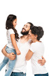 © LIGHTFIELD STUDIOS - bearded latin man holding in arms adorable daughter while smiling near wife isolated on white