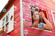© pikselstock - Boy blowing bubbles in a wooden playhouse