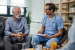© Drazen - Happy senior man talking with a doctor during home visit.