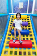 Leinwandbild Motiv Asian Chinese little girl playing at indoor playground