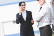 © LIGHTFIELD STUDIOS - selective focus of businesswoman talking on smartphone near man