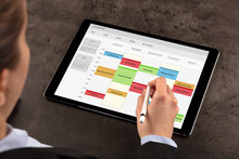 Business Woman Schedule Her Weekly Program On Tablet
