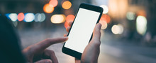 Closeup Image Of Male Hand Holding Smartphone With Blank Screen. Mockup Ready For Text Message Or Content. Man's Hands With Cellphone. Empty Display. Night Street, Bokeh Light