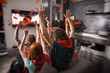 © alphaspirit - Group of friends watch a football game together on television and rejoice