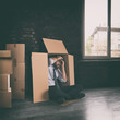 Businessman depressed for the failure of the company hidden in a cardboard box