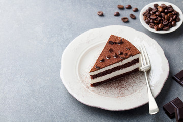 Wall Mural - Tiramisu cake with chocolate decotaion on a plate. Grey stone background. Copy space.