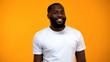© motortion - Cheerful Afro-American man smiling at camera isolated on yellow background