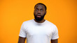 © motortion - Shocked African-American man looking at camera isolated on yellow background