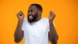 © motortion - Satisfied Afro-American man extremely happy, jackpot winning, luck and fortune