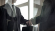 © motortion - Man handing over briefcase to another man in business suit, secret transfer