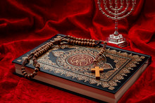Religious Coexistence, Monotheism And Abrahamic Religions Coexist In Peace Concept Theme With A Quran Representing Islam, A Cross And Rosary Symbolizing Christianity And Menorah A Symbol Of Judaism