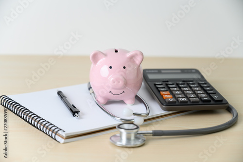 Fotomural Piggy bank with stethoscope financial checkup or saving for medical insurance c