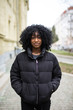 © F8  \ Suport Ukraine - Cheerful young african woman wearing coat walking outdoors in autumn street