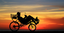 Silhouette Recumbent Bicycle On Sunrise 
