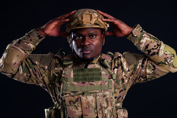 military army african male warrior camouflage suit sorrow sadness wrapped in an American flag black background studio ,lying violence news criminal media