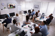 Businesspeople Attending Videoconference Meeting In Office