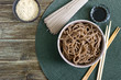 Cold soba (buckwheat noodles) with sauce and sesame. Japanese food. Traditional asian cuisine - noodles from buckwheat flour. Top view, flat lay.