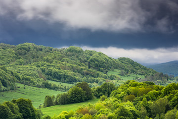 Wall Mural - Stormy weather with dramatic rainy clouds over green peaks in Carpathian Mountains, Bieszczady,Poland