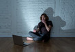 © SB Arts Media - Teenager man suffering Internet cyber bullying sitting alone with computer feeling hopeless