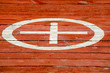 on the red flooring of the boards painted circle and a cross in it