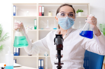 Young female chemist working in the lab 