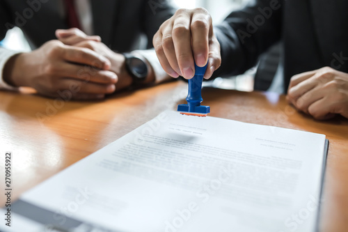 Fotomural Businessman stamping with approved stamp on document at meeting.
