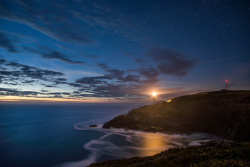 Wall Mural - starry night sky with clouds at trevose head on cornwalls north coast, uk