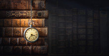 Vintage Clock Hanging On A Chain On The Background Of Old Books. Old Watch As A Symbol Of Passing Time. Concept On The Theme Of History, Nostalgia, Old Age. Retro Style.