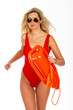 Pretty young blonde lifeguard in red sexy swimsuit with lifeguard rescue can floating buoy tubeon the white background Concept Woman in Swimsuite