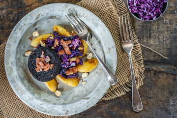 Canvas Print - Warm salad of red cabbage, black pudding and apple with crispy bacon and crushed hazelnuts - overhead view