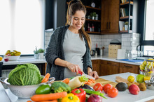 Beautiful Smiling Young Pregnant Woman Preparing Healthy Food With Lots Of Fruit And Vegetables At Home Kitchen