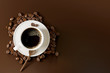 © aanbetta - Coffee cup with beans on dark brown background. 3d rendering