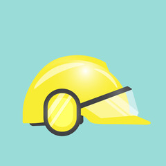 Safety and health concept with yellow helmet on green