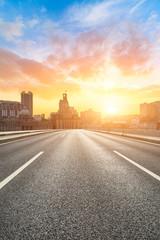 Shanghai bund city skyline and empty asphalt highway at sunset