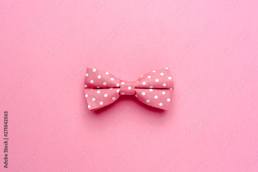 Bow-tie with polka dot on pink background - obrazy, fototapety, plakaty 