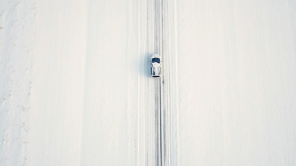 Top view of single car in middle of snow landscape