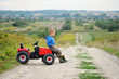 © Jacek - Child with a toy tractor on a trip.