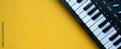 Cuadros en Lienzo close up top view electric keyboard music instrument on yellow background concep