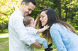 © MCStock - Happy Hispanic Family Having Fun Together Outdoors.