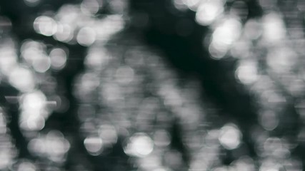 Wall Mural - abstract background footage. lots of moving bokeh lights. defocused video of sea surface glowing in 