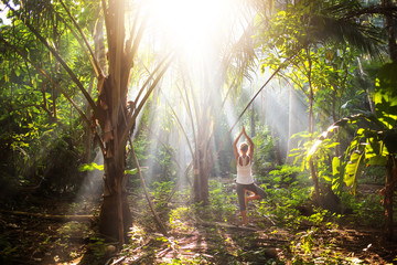 Poster - woman doing yoga outside in jungle