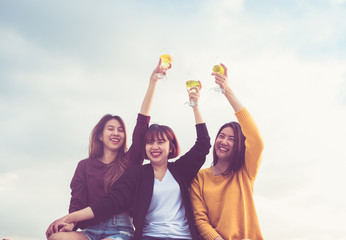 Happy group of asian girl friends enjoy laughing and cheerful sparkling wine glass at rooftop party,Holiday celebration festive,teeage lifestyle,freedom and fun