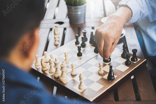 Cuadros en Lienzo Senior old man playing chess game on chess board for strategy and planning conce