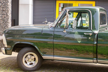 The Front Of A Green Vintage Pickup Truck