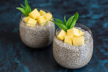 Beautiful and tasty dessert with mango and seeds of a chia. A fresh pudding with fruit for breakfast