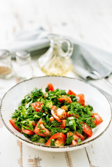 Wall Mural - Healthy tomato salad with cucmbers, dill, onion and parsley