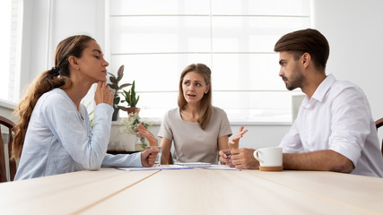 Wall Mural - Angry furious female boss scolding employees for bad work