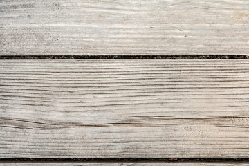 texture of an ancient wooden wall, old dried wood with a lot of cracks and peeling fibers, closeup abstract background