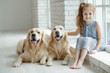 © nuzza11 - A child with an animal. Little girl with a dog at home.