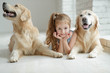 © nuzza11 - A child with an animal. Little girl with a dog at home.